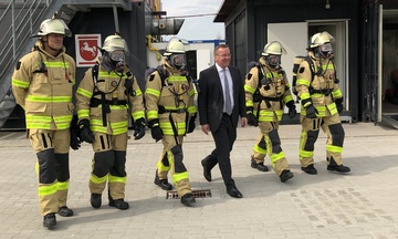 Seit an Seit: Der Minister mit den Einsatzkräften der Schiffsbrand-Simulationsanlage in Wilhelmshaven.